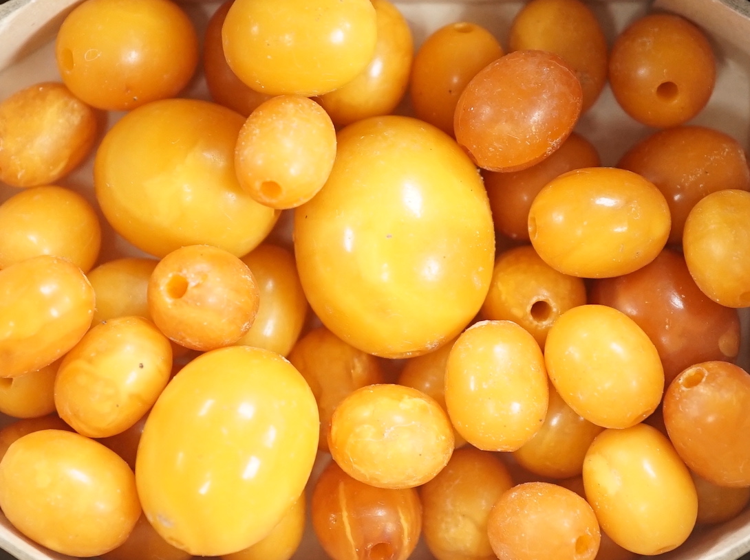 A group of loose graduated oval amber beads, 42 grams.